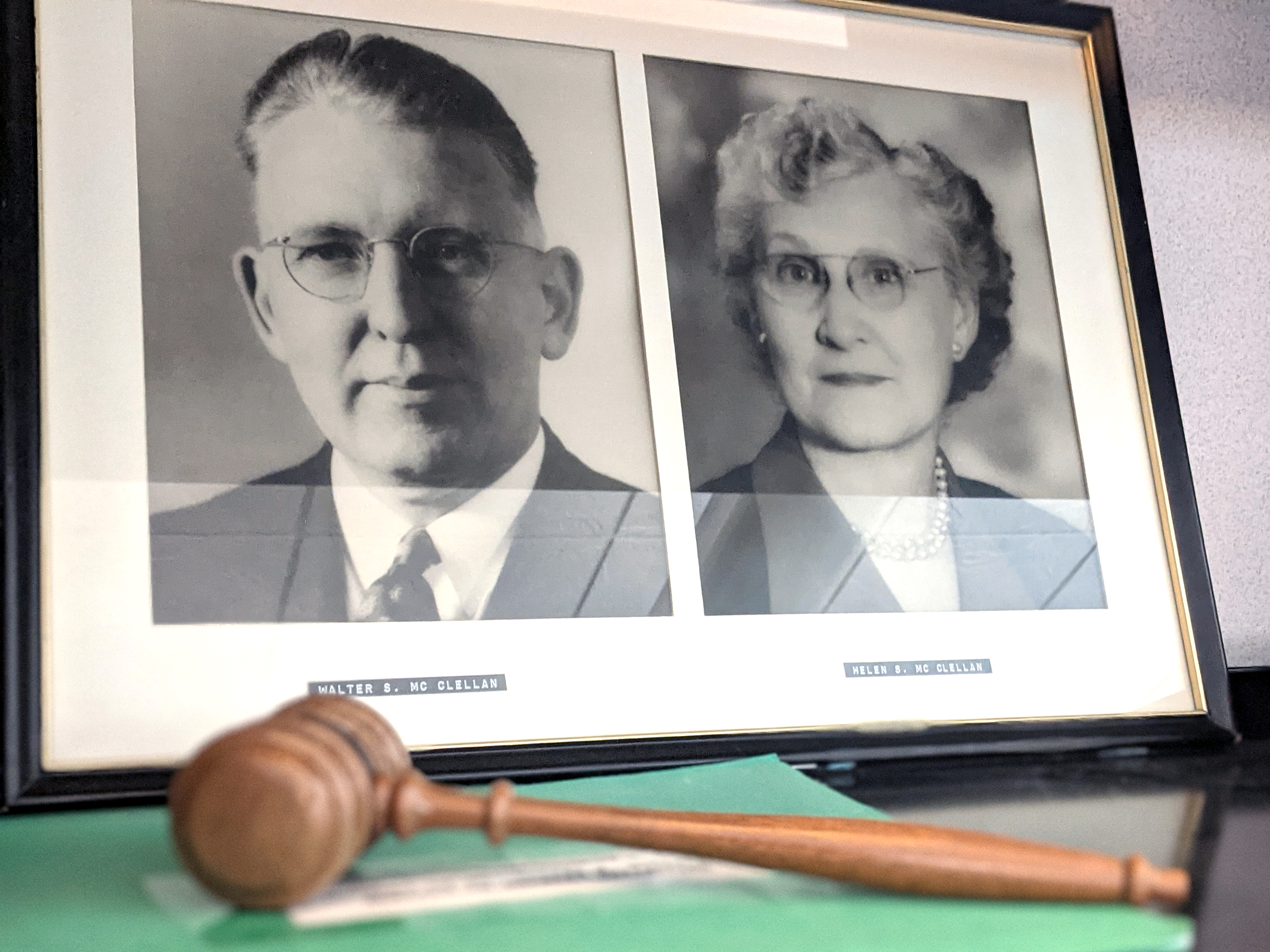 Two photos sharing a frame with a judge’s gavel laid in front.