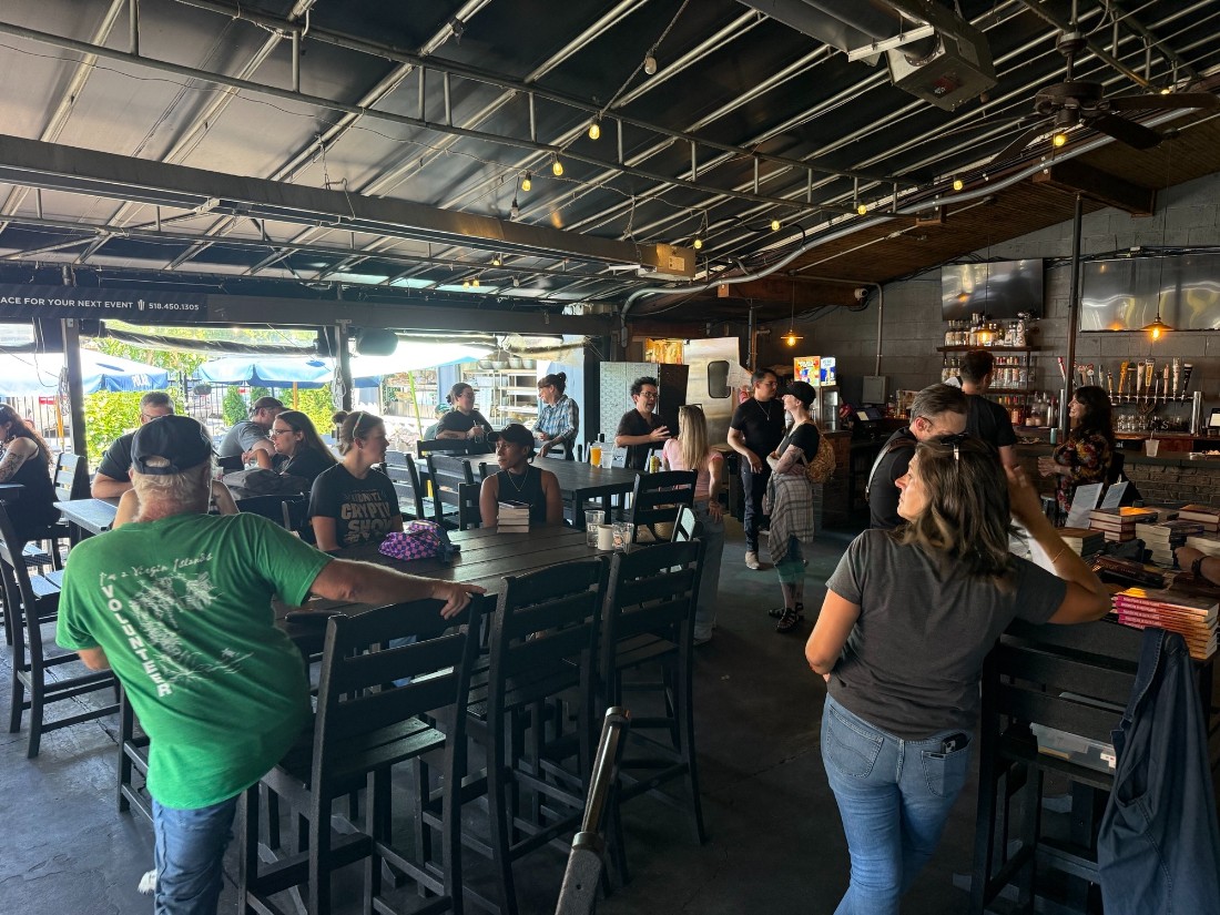Photo of people filling the outdoor covered patio and bar area of Bailey’s Cafe in Saratoga springs minutes before the Summer Scares authors begin speaking.