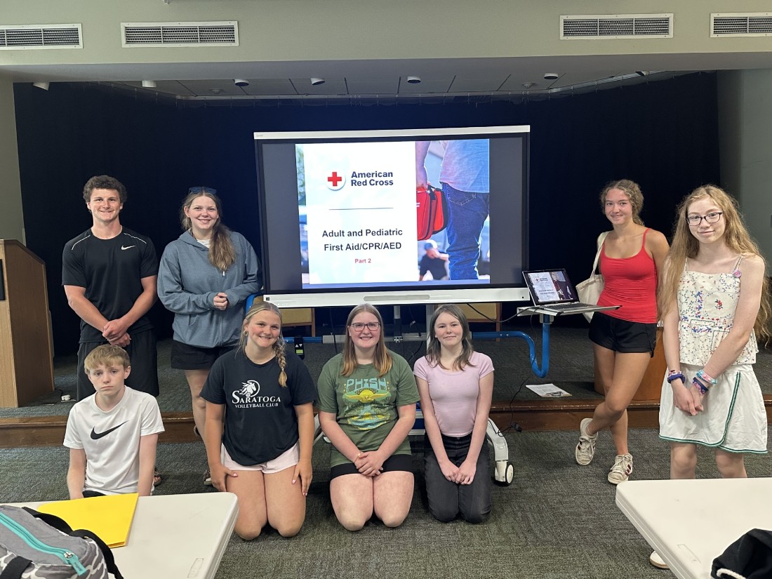 group of teens pose for a photo after completing a CPR class at the library