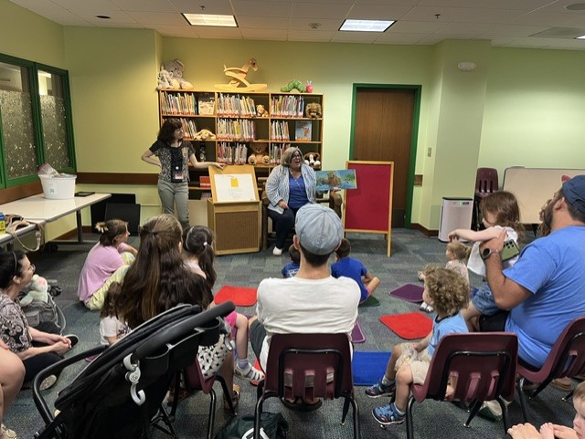 assemblywoman woerner reads a book to children at the library
