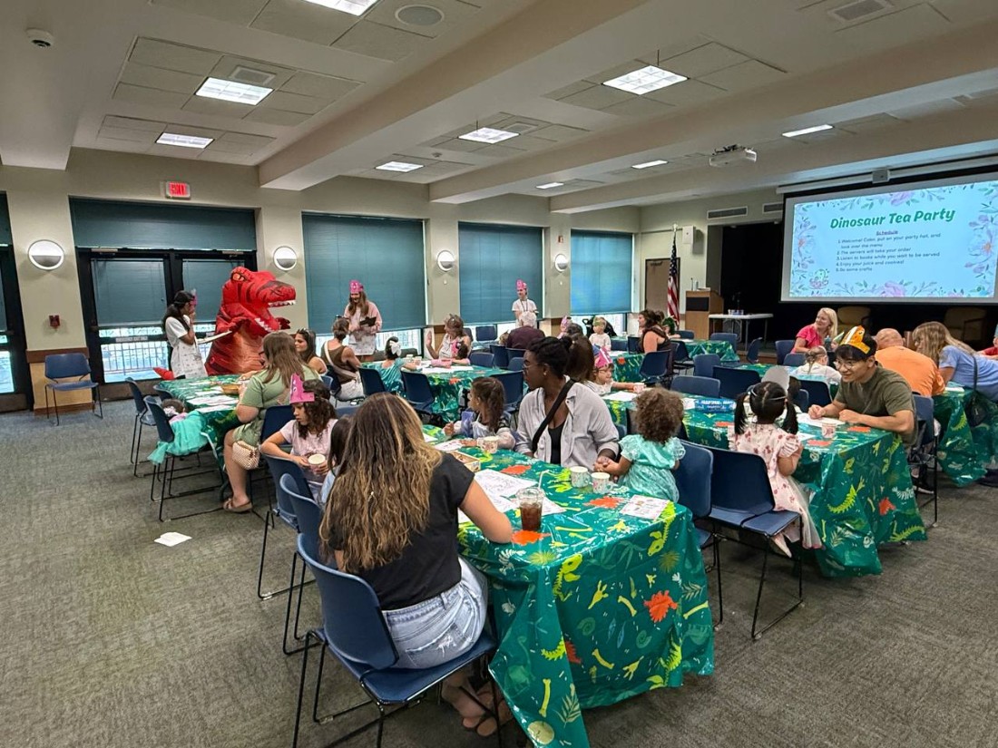 families drink tea at a library dinosaur tea party