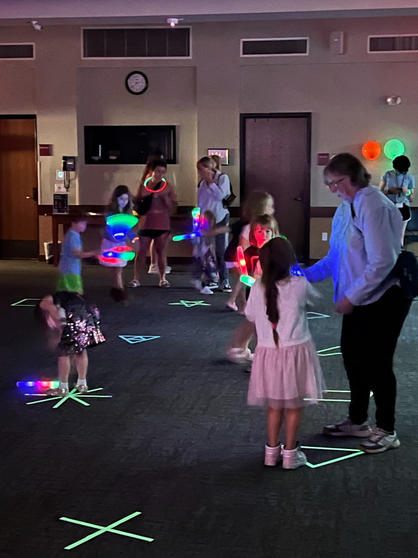 Partiers enjoy a day time glow party at the library