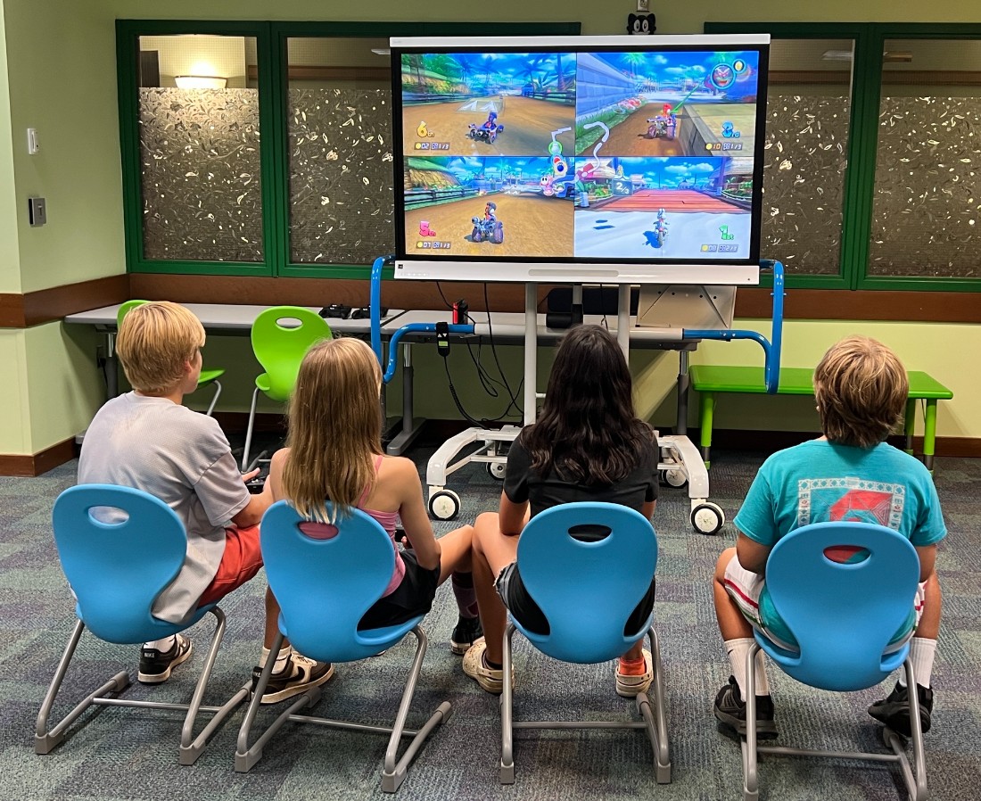 Kids and teens play Mario Kart on the Switch