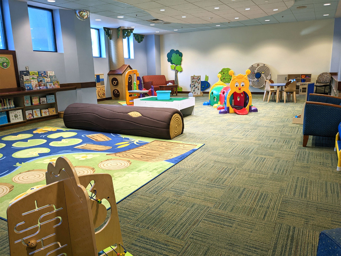 A slightly open area with many tactile and interactive learn-and-play items scattered throughout.