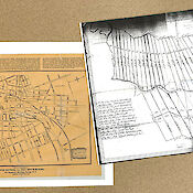 Two old area maps laid next to one another. One is brown, showing real estate. The other is darkened white showing a land survey.