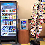 Thumbnail: Fully stocked refrigerated drink storage, and chip bag stand.