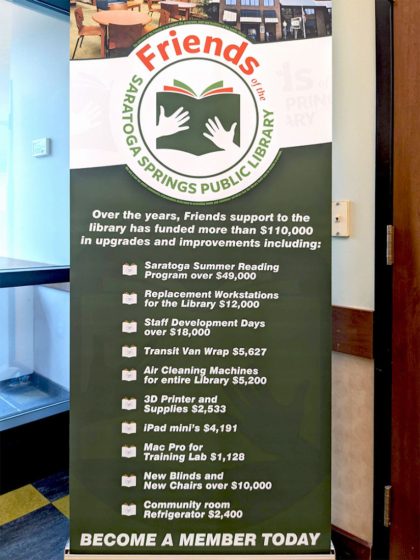 Large advertisement banner for the Friends of the Library organization exclaiming the benefits of membership.